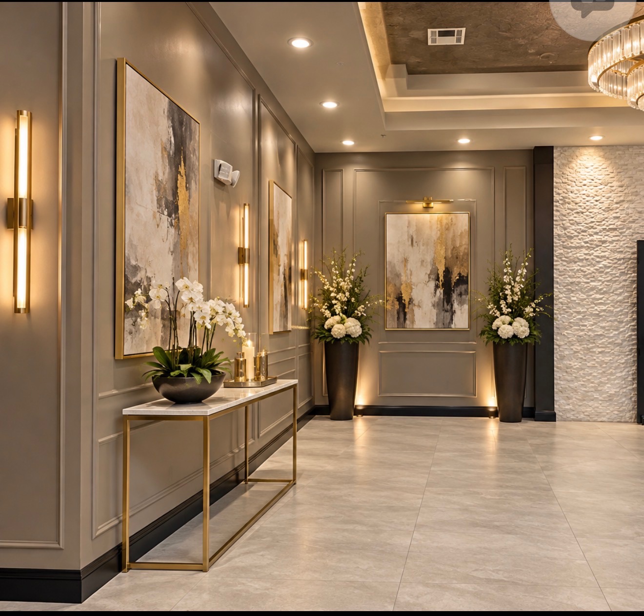 Prefunction gallery hallway with art, console, and floral accents